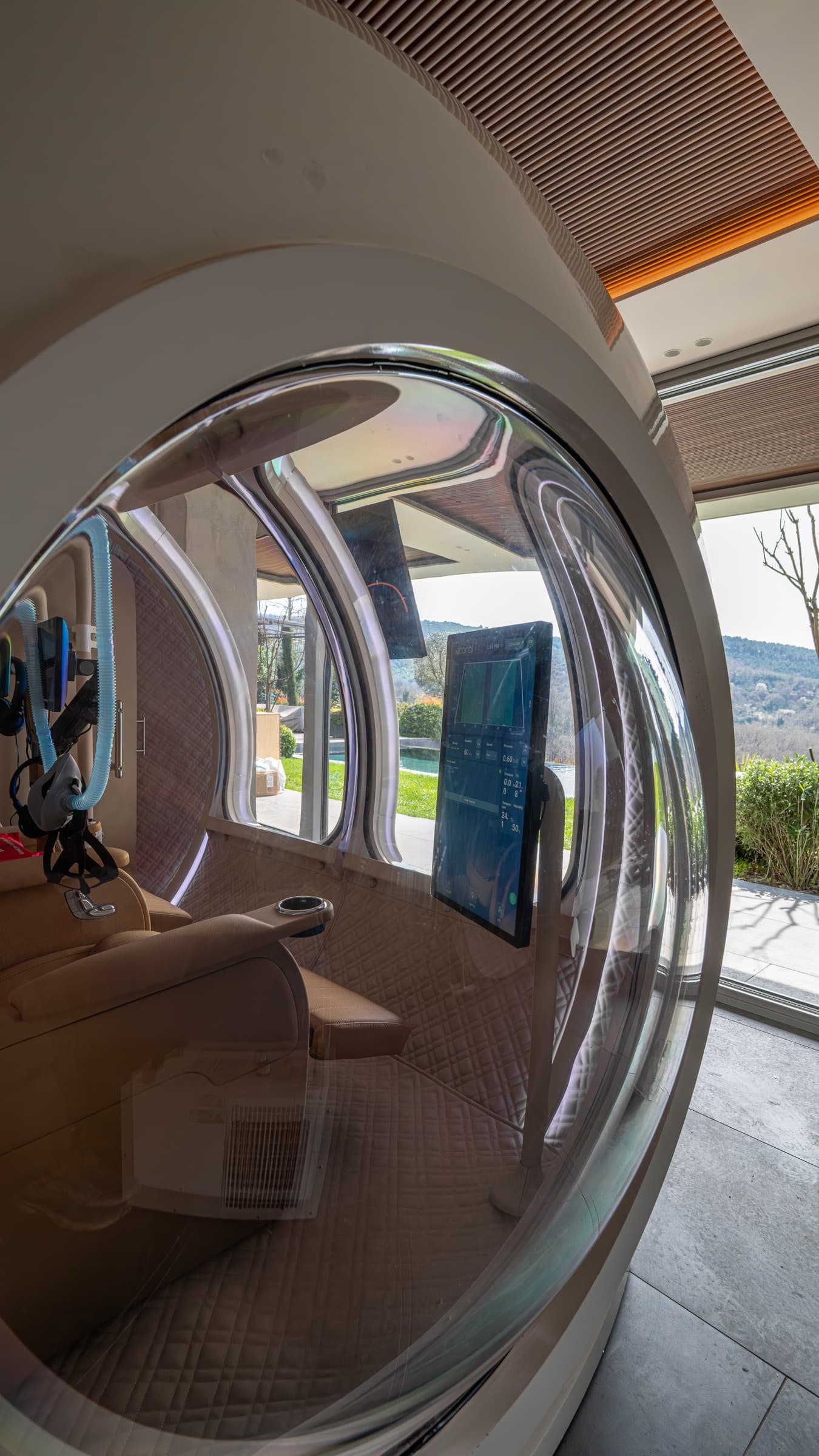 Interior porthole view showing the cabin and landscape beyond