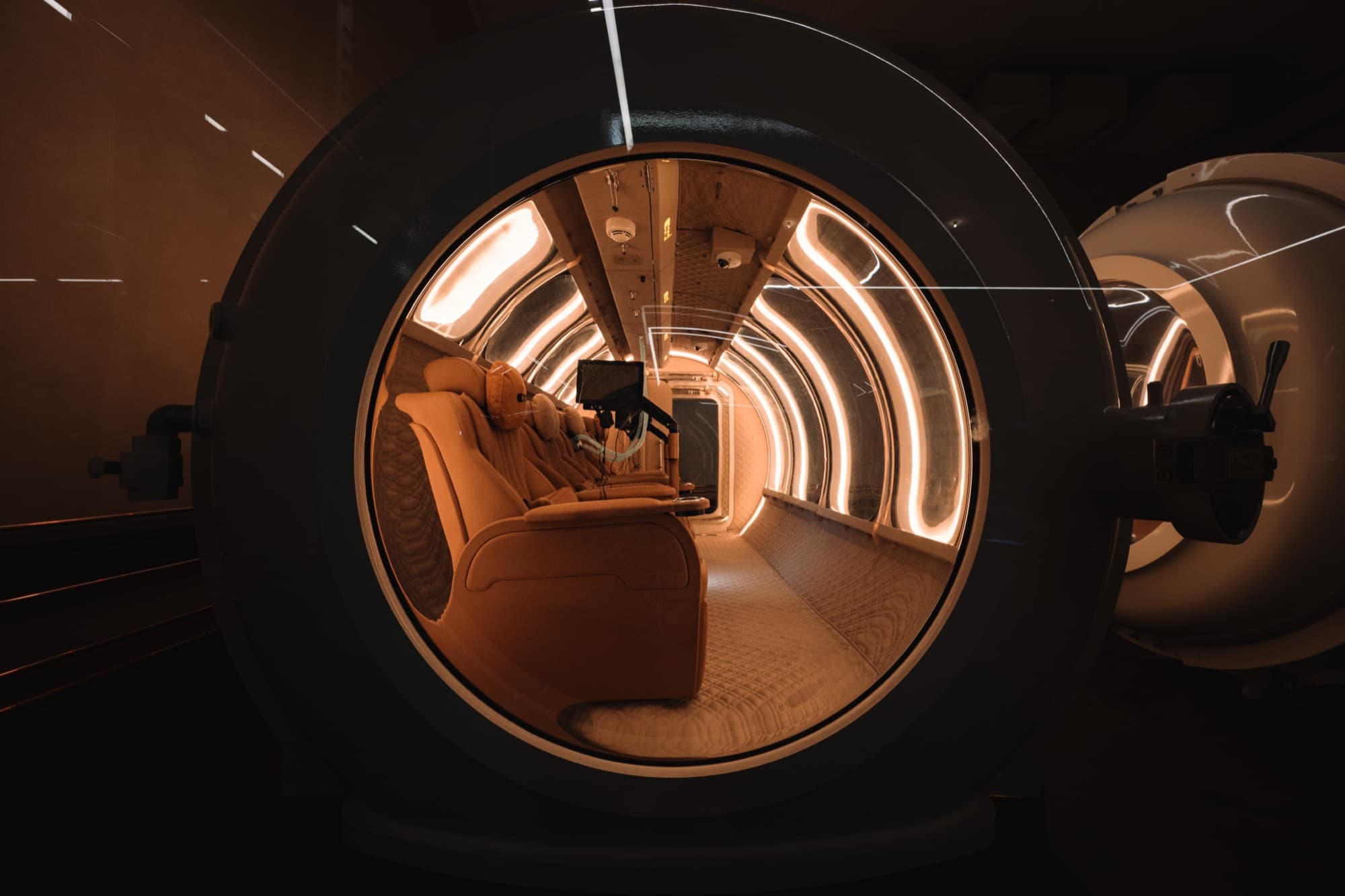 Looking through a Coral Ark porthole into the lit cabin interior