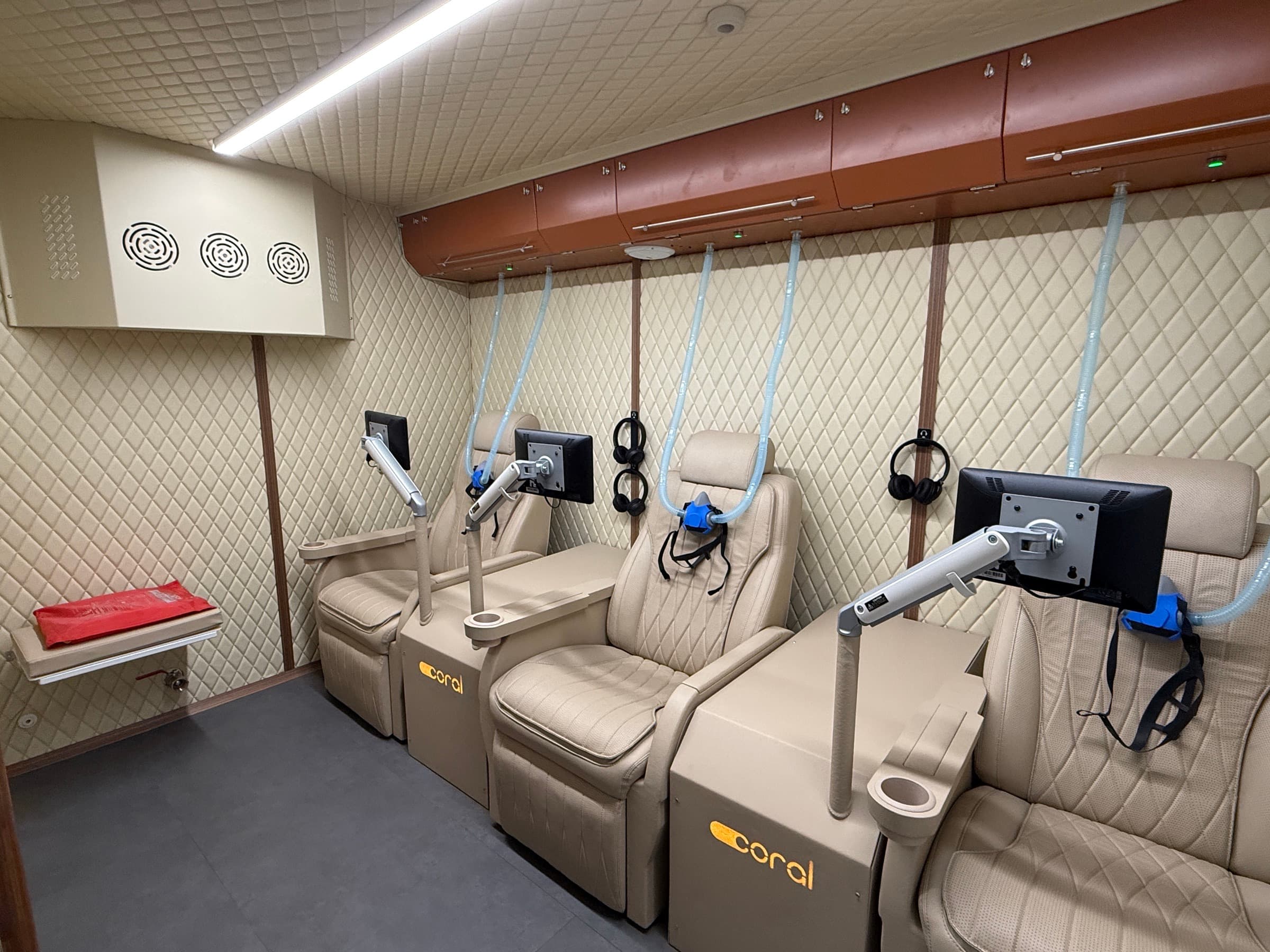 Coral Cube interior with cream leather seats and wall-mounted control arms