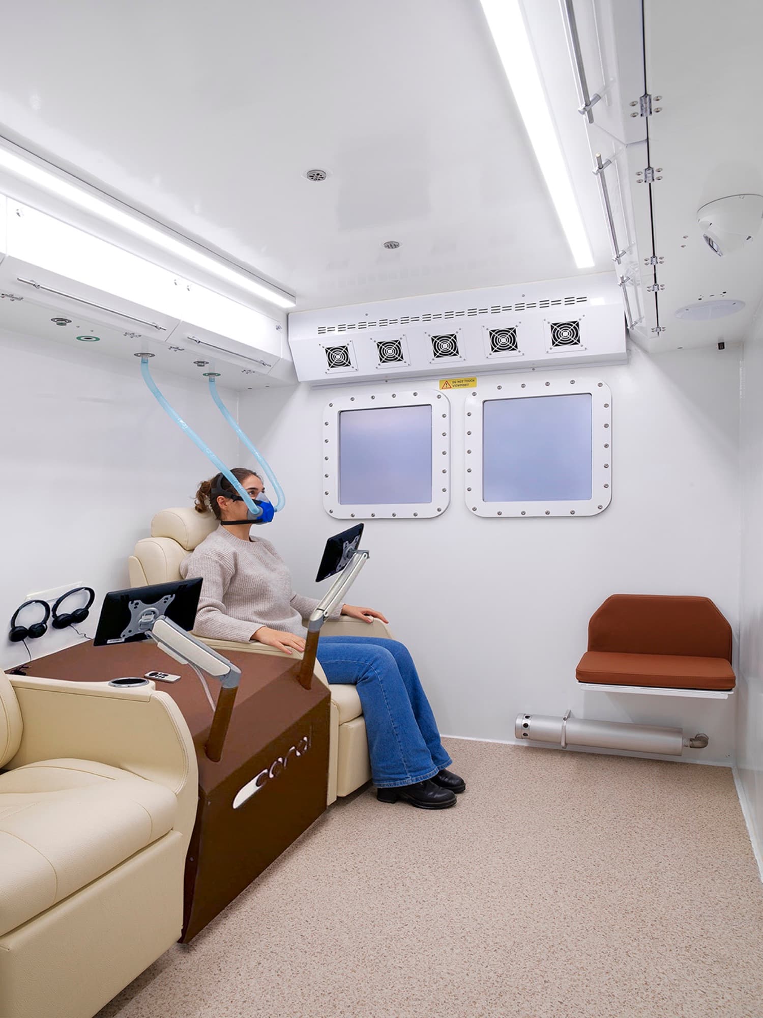 Coral Cube cabin interior in Qatar, two cream-leather session seats