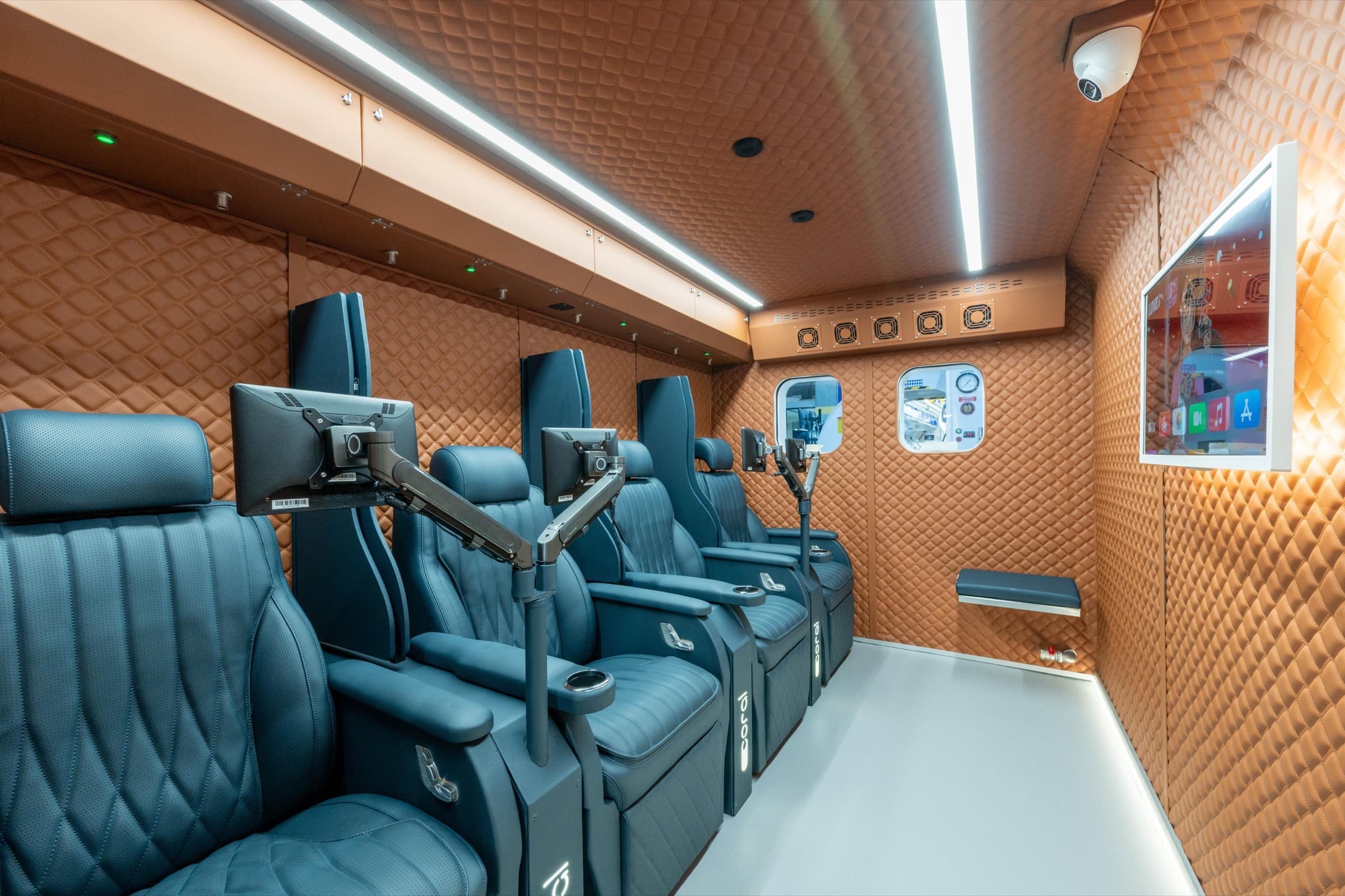 Coral Cube interior showing the full row of reclining session seats