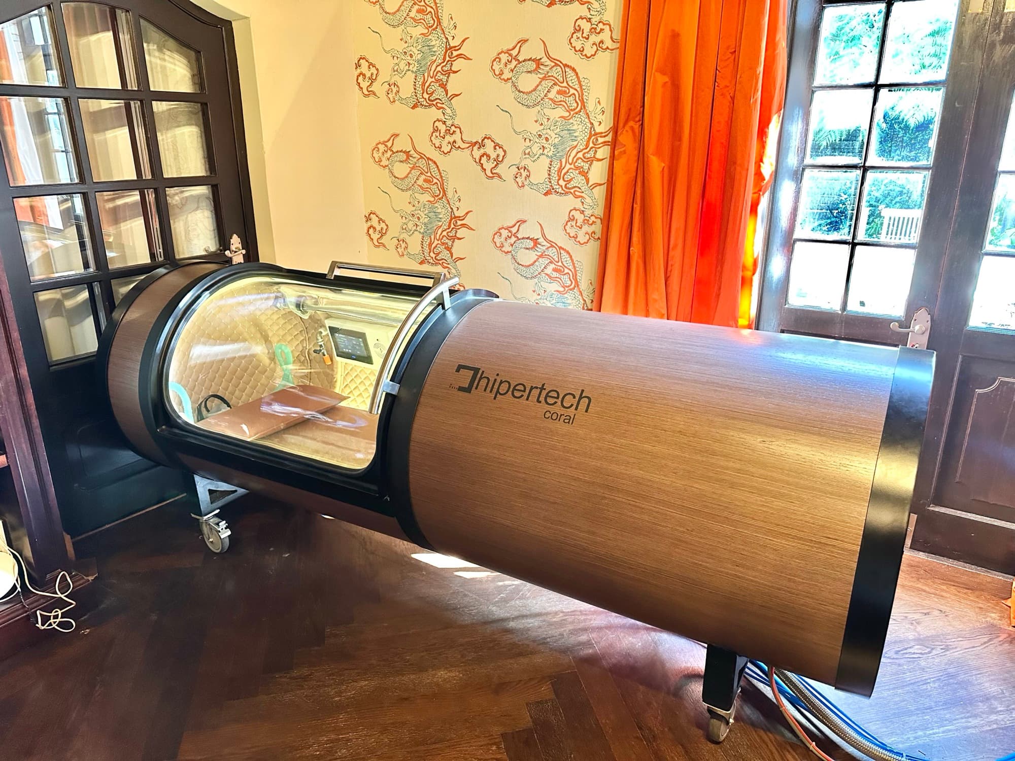 Coral One installed in a residence, ornate wallpaper and warm wood floor