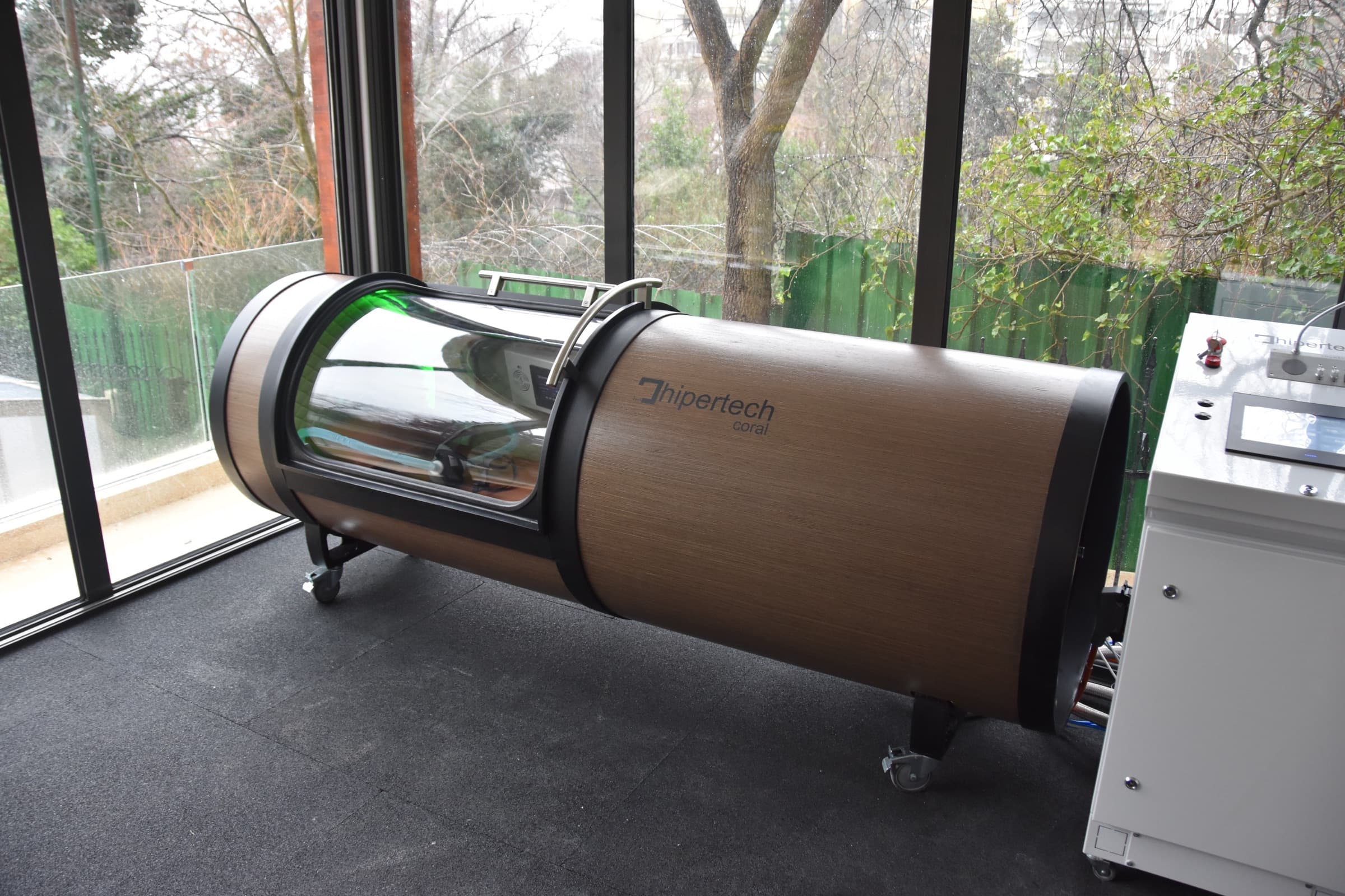 Coral One in a glass-walled showroom, horizontal chamber form highlighted