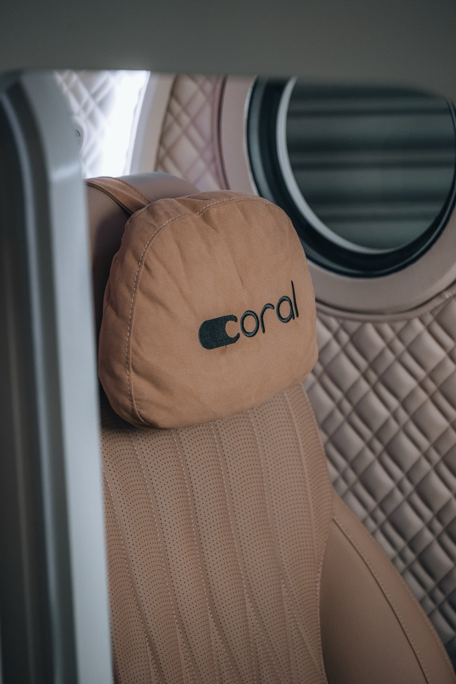 Coral Pod headrest detail with coral branding