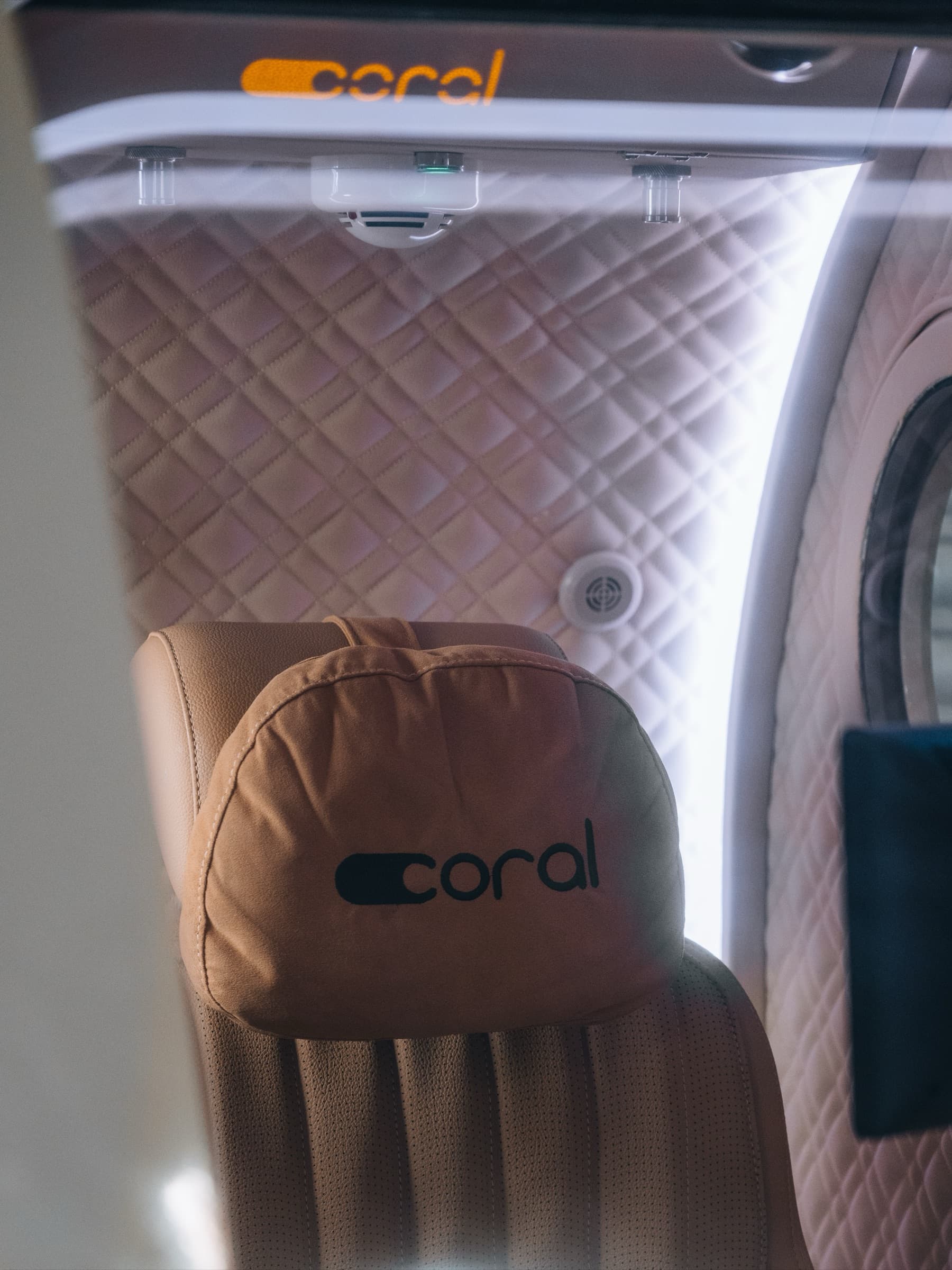 Interior of the Coral Pod, leather seat visible through the porthole
