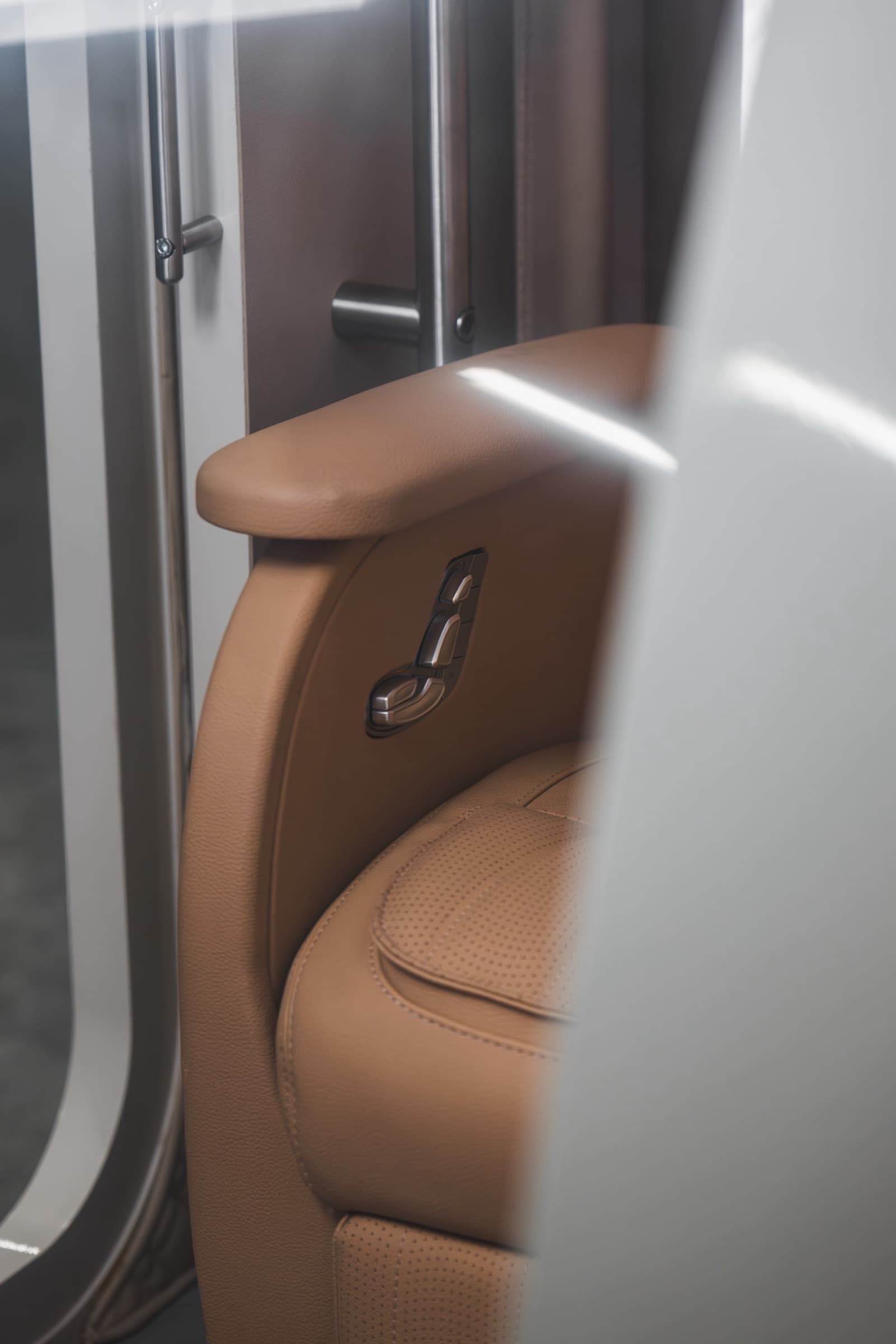 Coral Pod seat detail with perforated leather and door mechanism visible